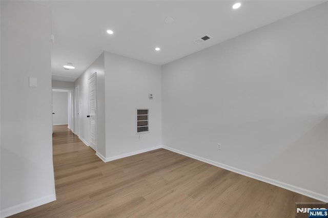 unfurnished room featuring visible vents, recessed lighting, baseboards, and wood finished floors