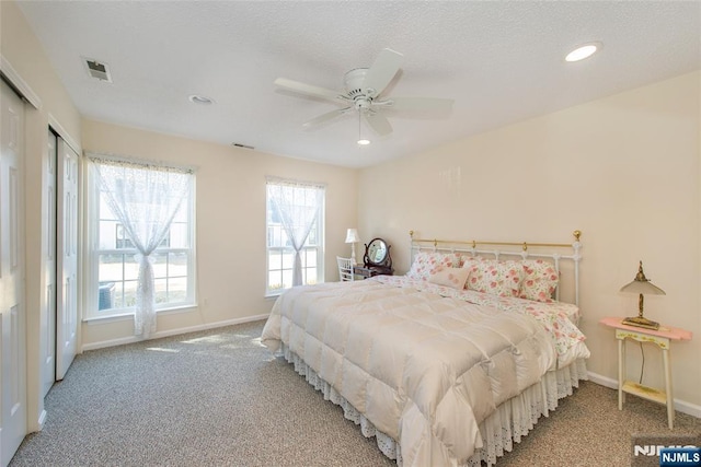 carpeted bedroom featuring visible vents, recessed lighting, a ceiling fan, and baseboards