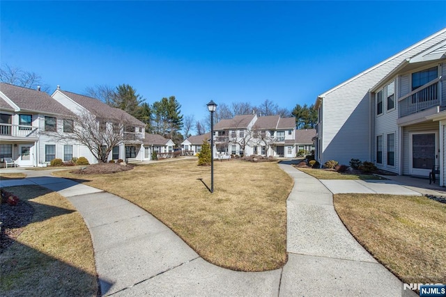 view of community with a residential view and a yard