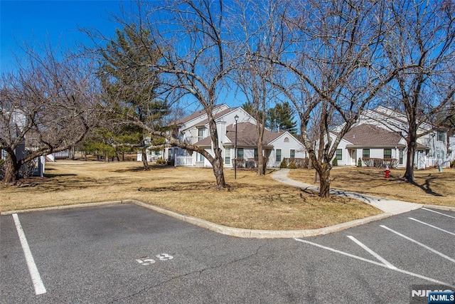 uncovered parking lot with a residential view