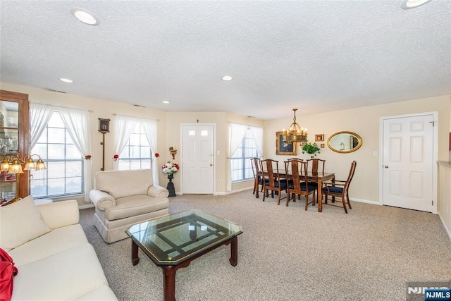 carpeted living room featuring visible vents, baseboards, a chandelier, recessed lighting, and a textured ceiling