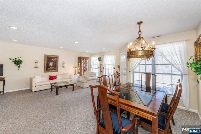 carpeted dining space featuring recessed lighting, baseboards, visible vents, and a textured ceiling