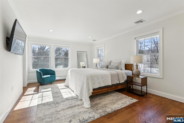 bedroom with wood finished floors, baseboards, visible vents, recessed lighting, and ornamental molding