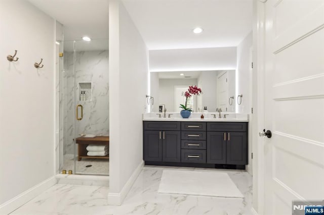 full bath featuring a marble finish shower, marble finish floor, baseboards, and double vanity