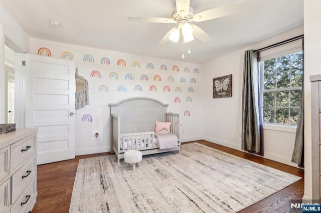 bedroom featuring baseboards, dark wood-style flooring, and ceiling fan