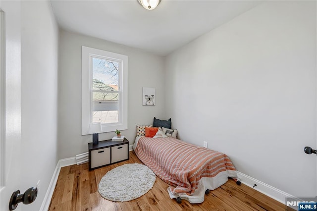 bedroom featuring baseboards and wood finished floors