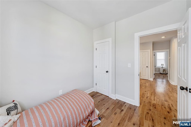 bedroom featuring light wood-type flooring and baseboards