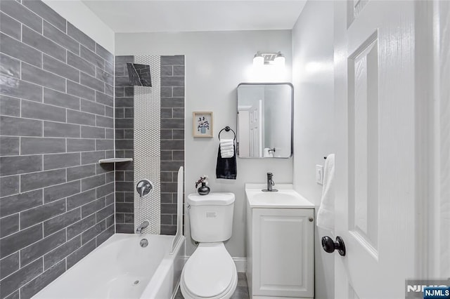 full bathroom featuring vanity, bathing tub / shower combination, and toilet