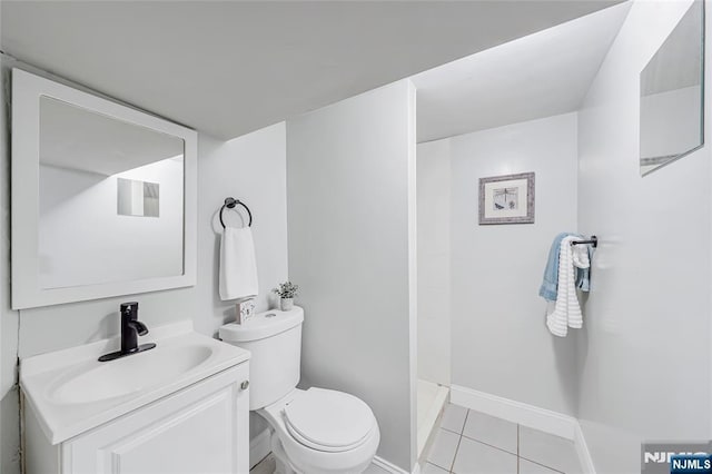 full bathroom with vanity, baseboards, a stall shower, tile patterned floors, and toilet