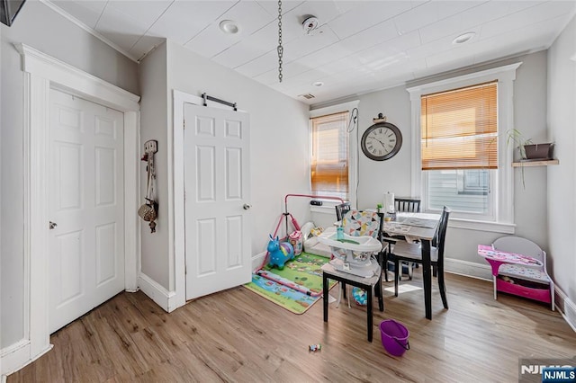 game room featuring baseboards and wood finished floors