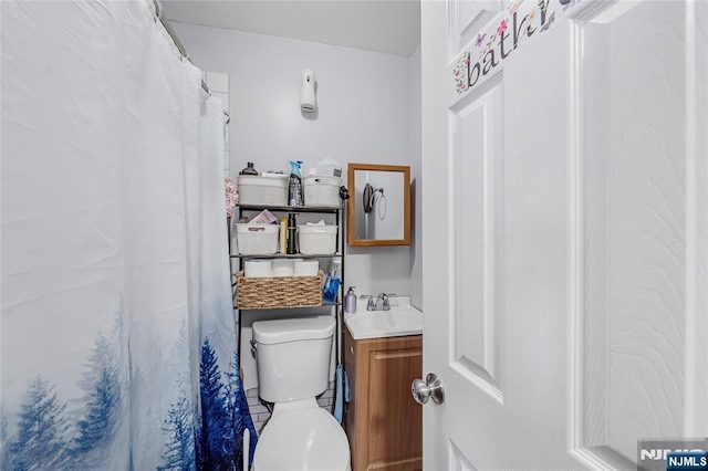 bathroom with toilet and vanity