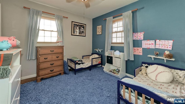 carpeted bedroom with baseboards and a ceiling fan