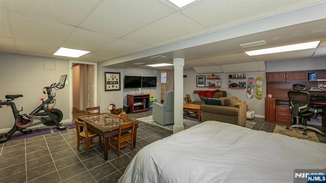 bedroom featuring dark tile patterned flooring, a paneled ceiling, and visible vents