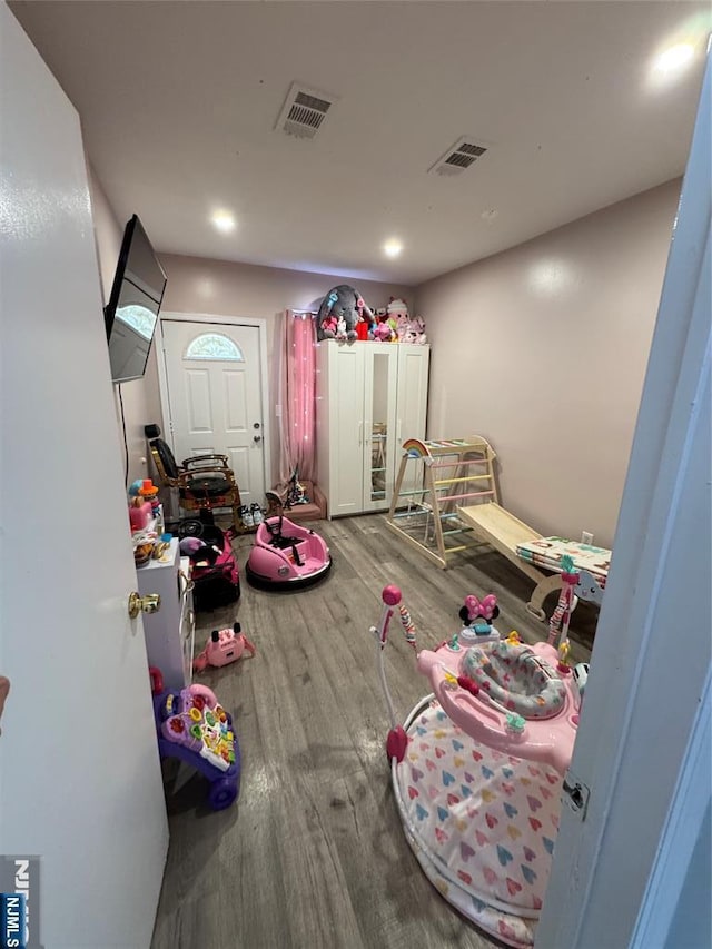 interior space with recessed lighting, wood finished floors, and visible vents