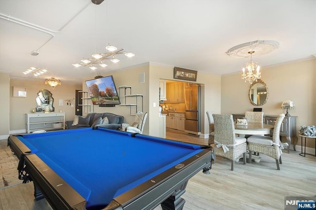 rec room with pool table, baseboards, light wood-type flooring, ornamental molding, and an inviting chandelier