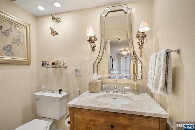 bathroom featuring toilet and vanity