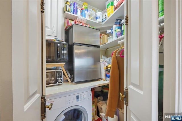 laundry room with laundry area and washer / dryer