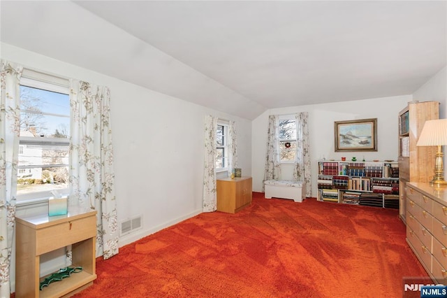 living area with visible vents, carpet flooring, and lofted ceiling