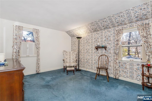 living area featuring baseboards, carpet floors, and a healthy amount of sunlight