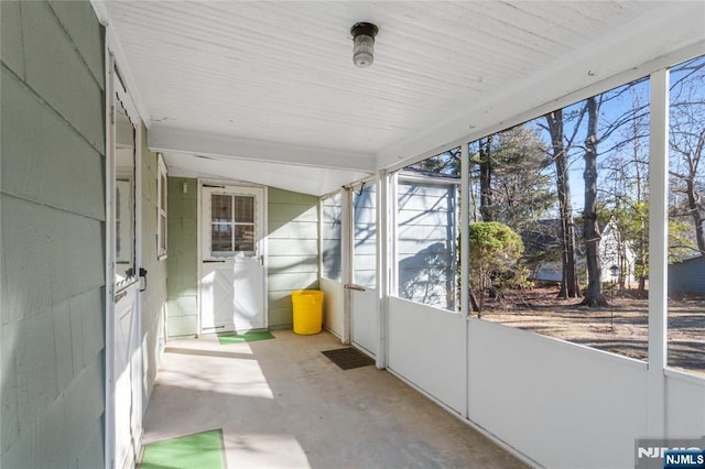 unfurnished sunroom with vaulted ceiling and plenty of natural light