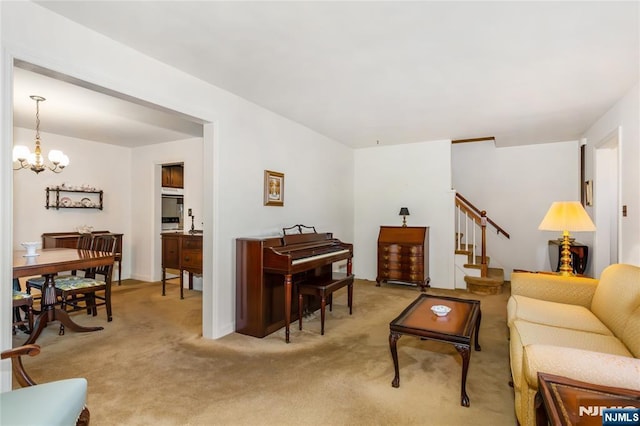 living room featuring stairway, light carpet, and a notable chandelier