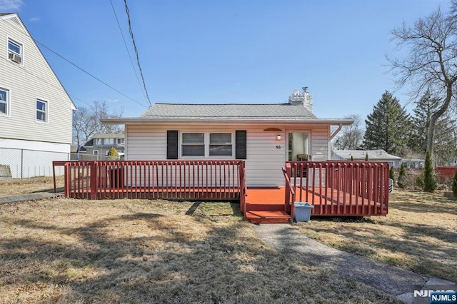 56 Calumet Ave, Par-Troy Hills Twp, NJ 07034 - view of front facade featuring a deck, a front yard, fence, and a chimney
