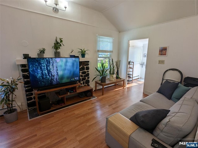 living area featuring wood finished floors and vaulted ceiling