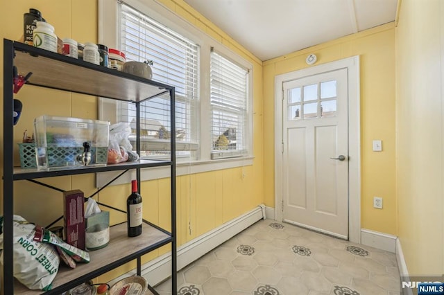 doorway featuring a baseboard heating unit and baseboards