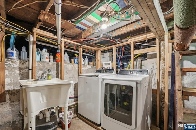 laundry area featuring laundry area, washer and dryer, and a sink