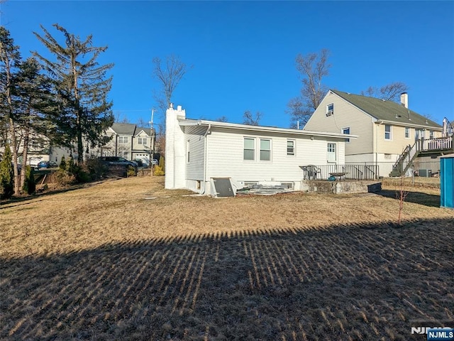 rear view of property with a chimney