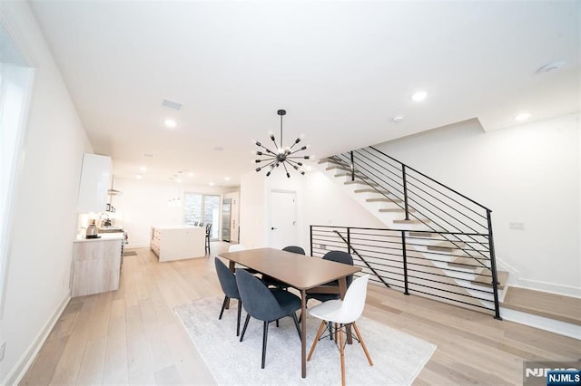 dining space with light wood-type flooring, visible vents, recessed lighting, a chandelier, and stairs