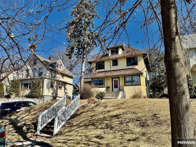 american foursquare style home with stucco siding