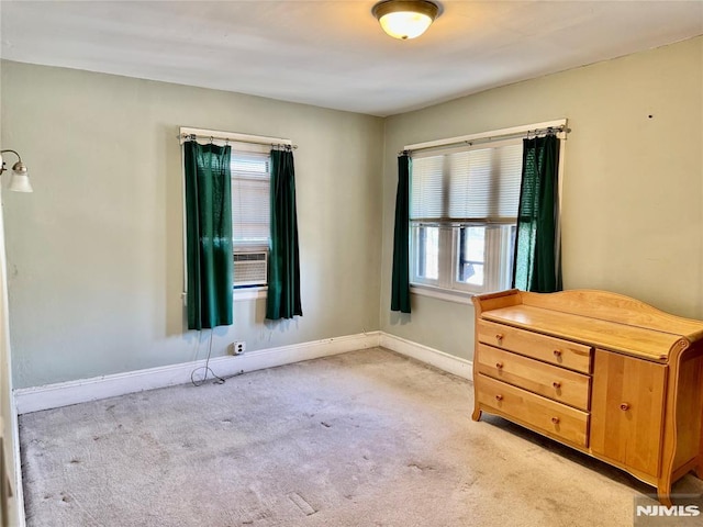 unfurnished bedroom featuring light colored carpet and baseboards