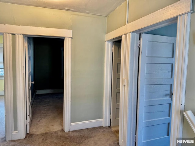 hall with carpet flooring and baseboards