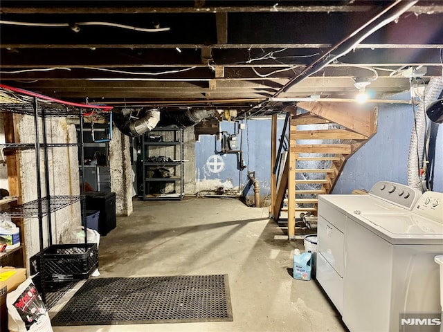 unfinished basement with separate washer and dryer and stairs