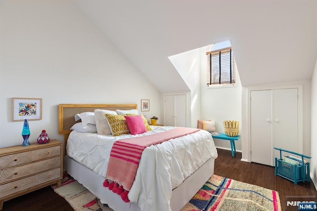 bedroom featuring lofted ceiling and wood finished floors