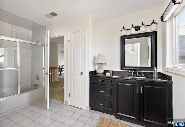 full bathroom with tile patterned floors, visible vents, bath / shower combo with glass door, and vanity