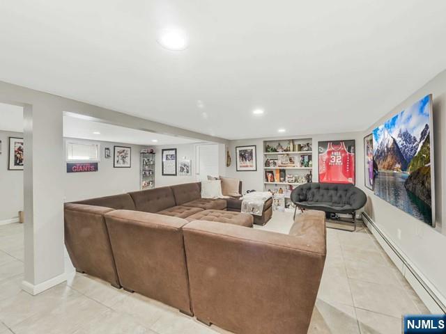 living area featuring built in shelves, baseboards, light tile patterned flooring, recessed lighting, and baseboard heating