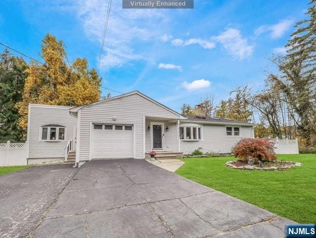 single story home with a front lawn, fence, a chimney, a garage, and driveway