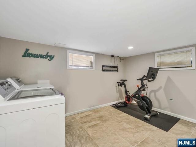 workout room with washer and dryer and baseboards