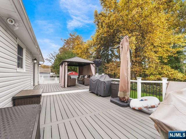 deck with a gazebo and area for grilling