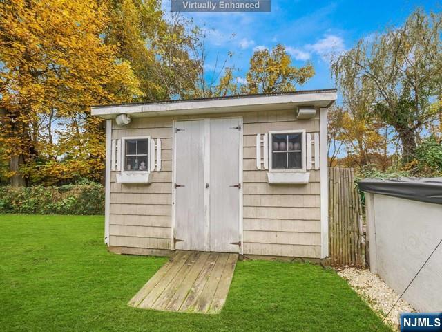 view of shed featuring fence