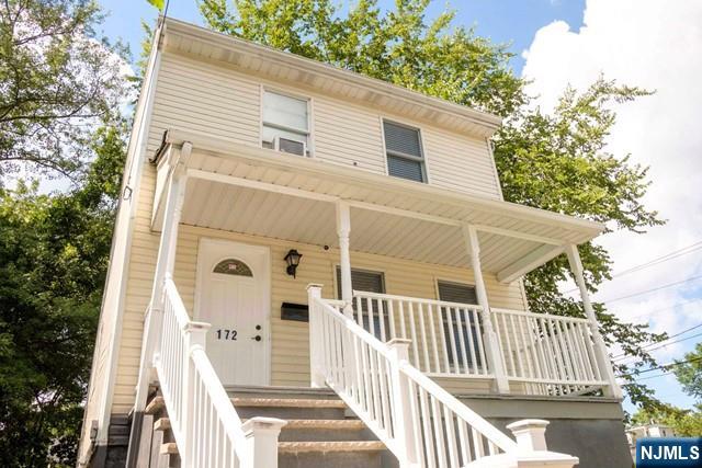 view of front of home with stairs and covered porch