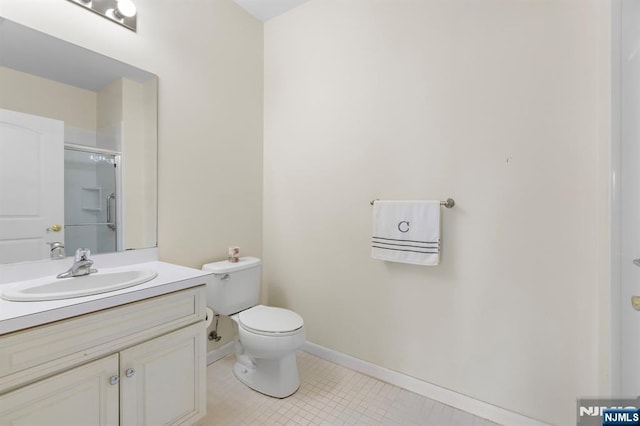 bathroom featuring baseboards, toilet, tile patterned floors, an enclosed shower, and vanity