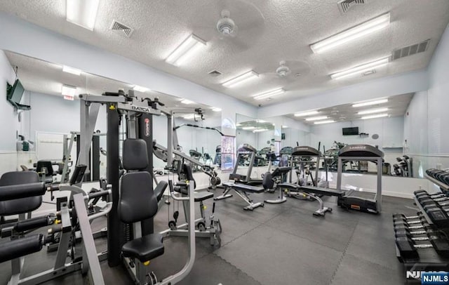 gym featuring visible vents and a textured ceiling