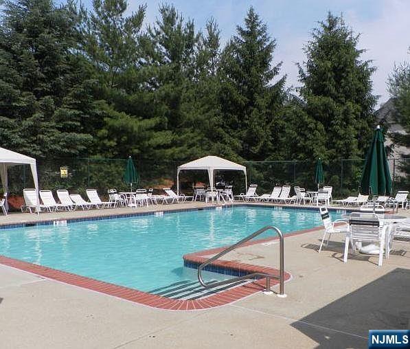 community pool featuring a gazebo, a patio, and fence