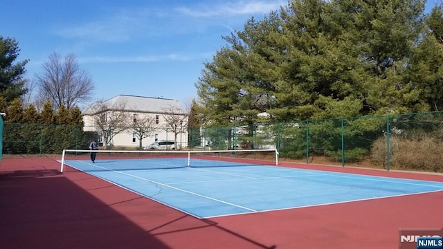 view of sport court with fence