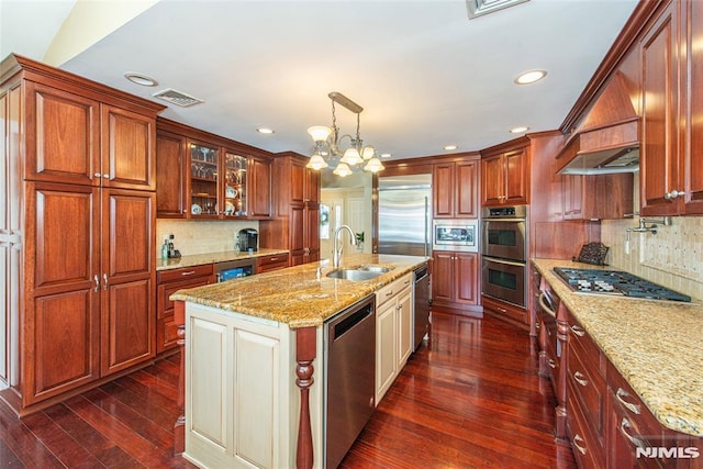 kitchen with visible vents, built in appliances, light stone counters, dark wood-style floors, and a sink