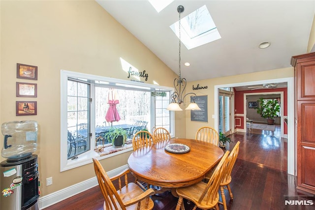 dining space featuring vaulted ceiling with skylight, recessed lighting, baseboards, and dark wood-style flooring