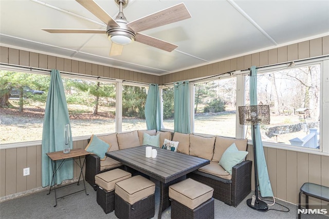 sunroom / solarium featuring a wealth of natural light and a ceiling fan